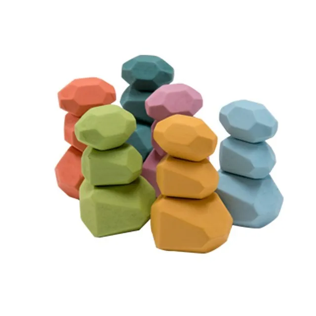 Colorful geometric stone toys stacked on a white background - rock