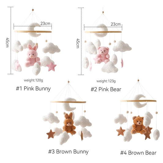 Nursery mobile with pink bunny, brown bear, and brown bunny toys on a white background