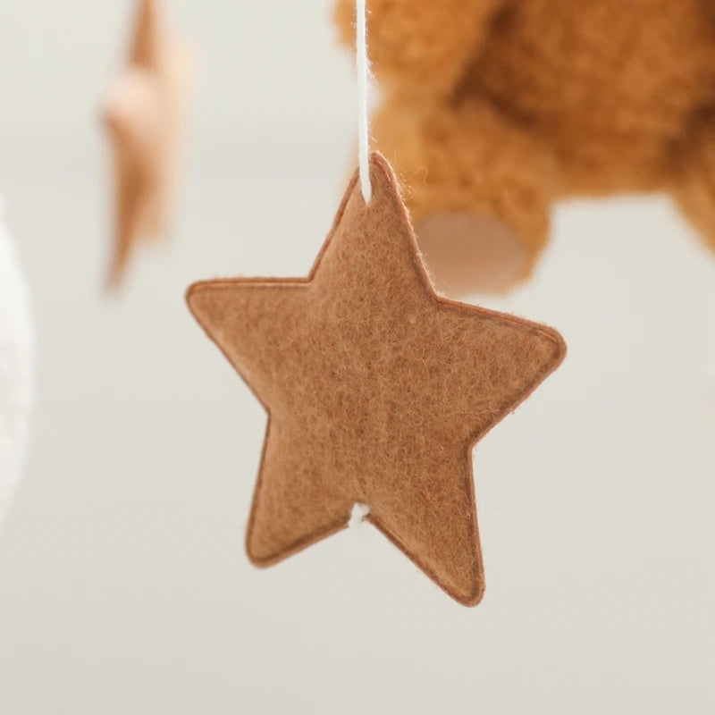 Brown star-shaped ornament hanging against a blurred background