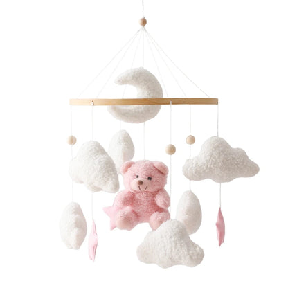 Baby mobile with pink teddy bear and white clouds on a white background