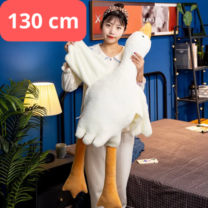 Person holding a large plush duck toy with dimensions displayed, in a room setting. 130cm goose