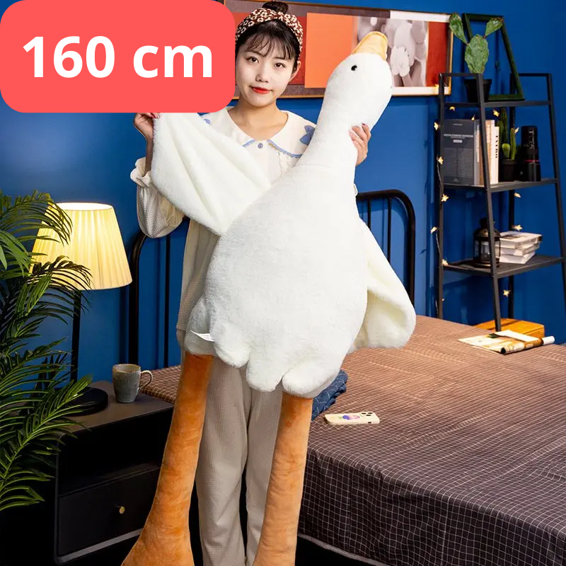 Person holding a large plush goose toy with a measurement label in a room. 160cm goose