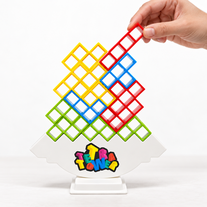 Hand placing a red hollow block on the Tetra Tower balancing game.