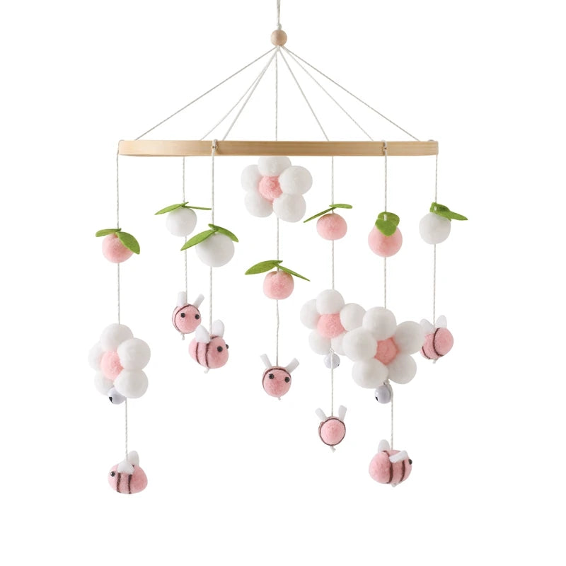Decorative mobile with hanging flowers and bees on a white background