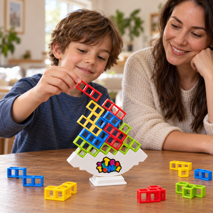 Child placing a red stacking piece on the Tetra Tower balancing game while an adult watches.