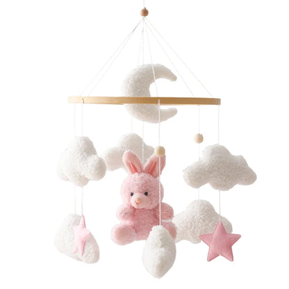 Baby mobile with pink bunny, clouds, and star on a white background