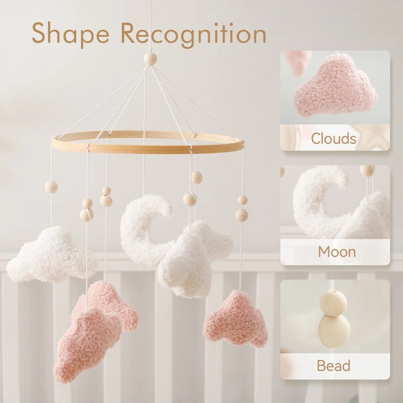Decorative hanging mobile with cloud, moon, and bead shapes on a light background.