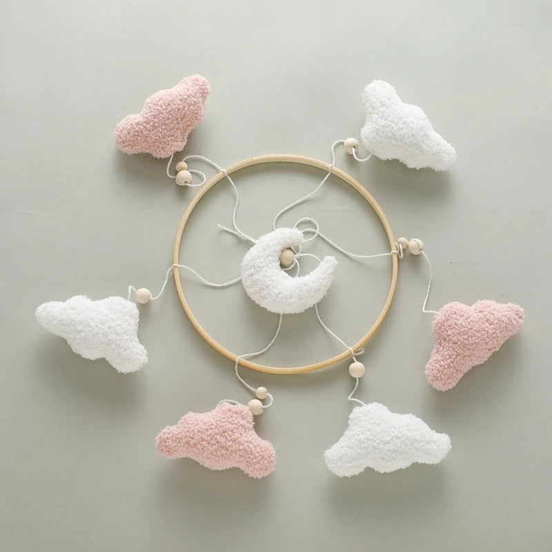 Decorative wall hanging with cloud shapes on a light gray background