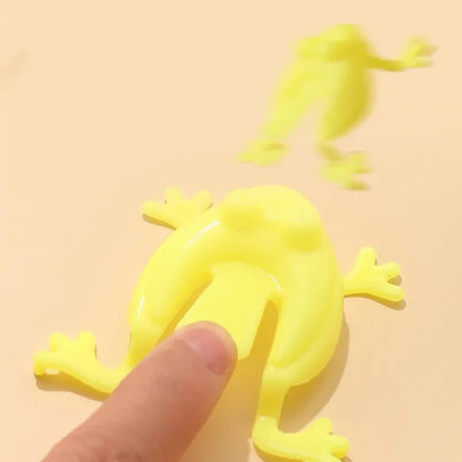 Yellow frog-shaped object with a finger for scale on a yellow background