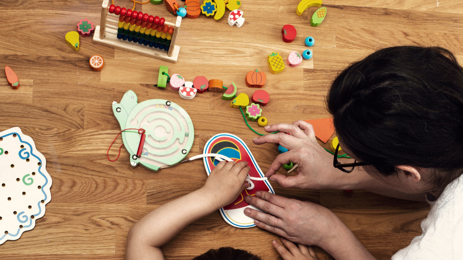 Teacher and Toddler play with montessori toy. GadWitch Toy Store