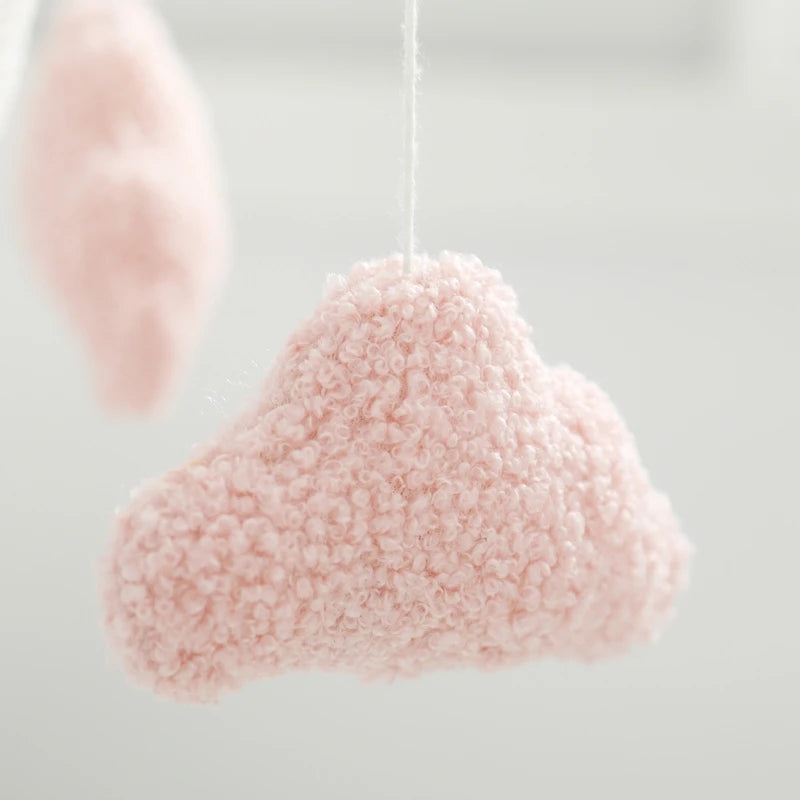 Pink cloud-shaped decorative item on a white background