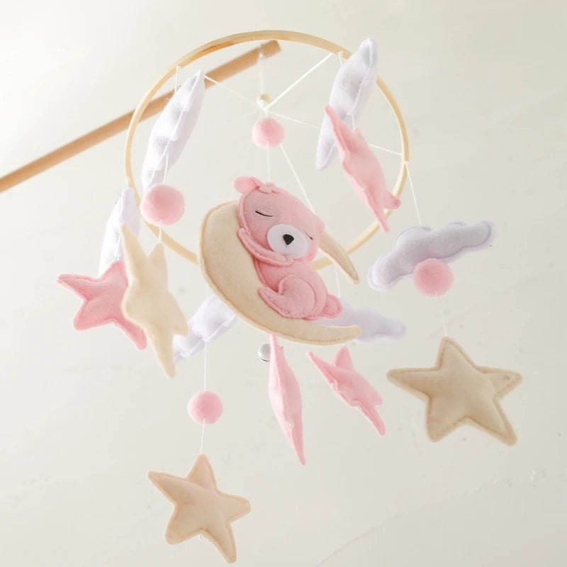 Baby mobile with pink teddy bear and stars on a white background