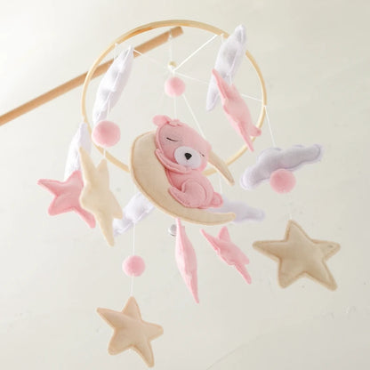Baby mobile with pink teddy bear and stars on a white background