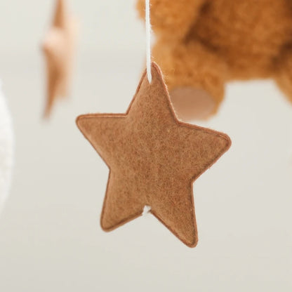 Brown star-shaped ornament hanging against a blurred background