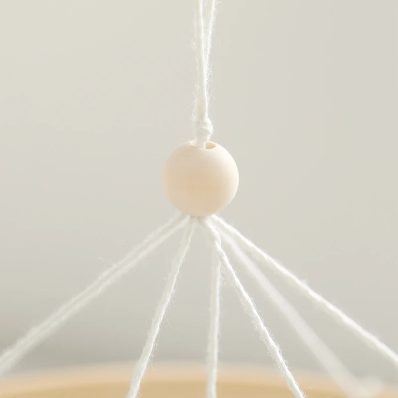 White spherical object with string on a light gray background