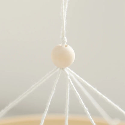 White spherical object with string on a light gray background
