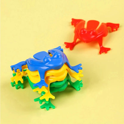 Colorful plastic frogs on a yellow background