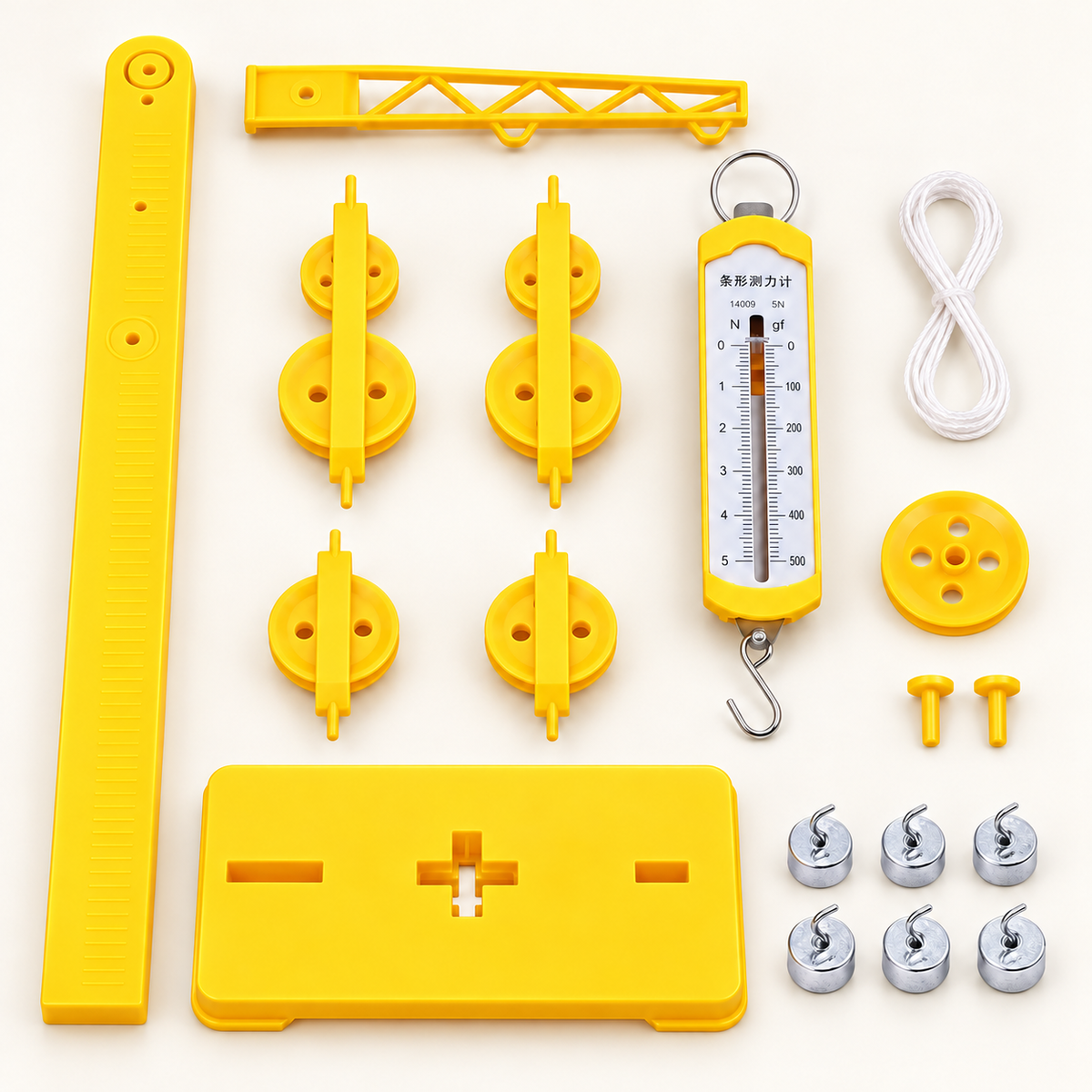 Yellow pulley experiment kit arranged on a light background, including a support column and base, pulley units, spring force meter, six metal hook weights, cord and fixing pins.