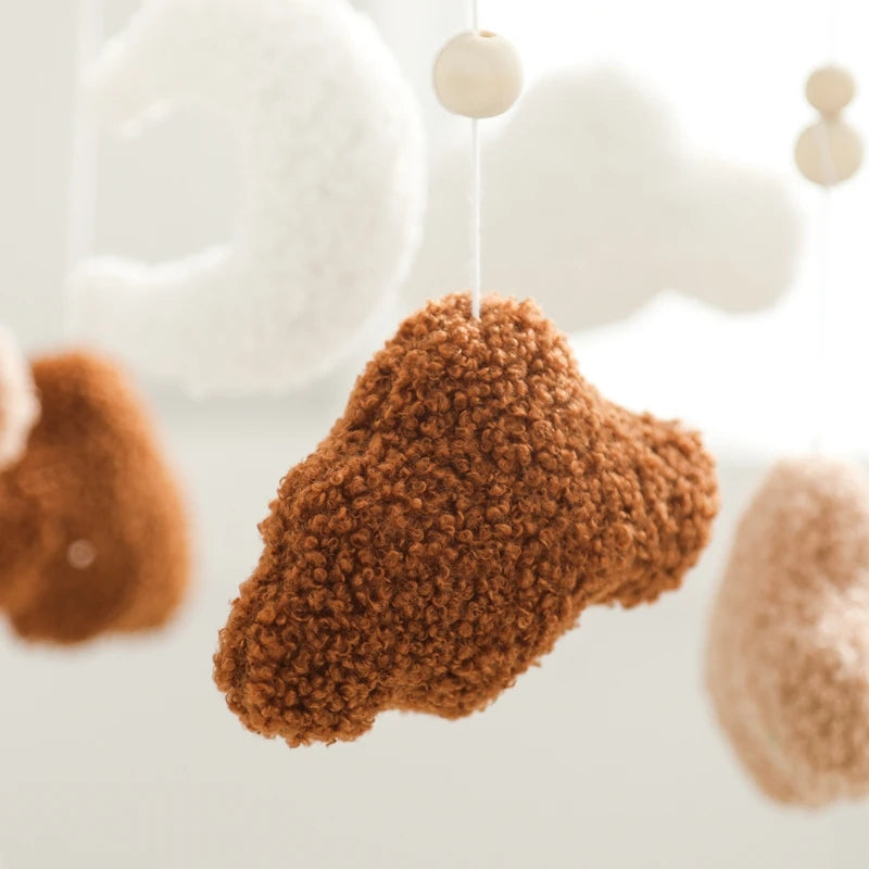 Brown textured ornament hanging on a string with blurred background