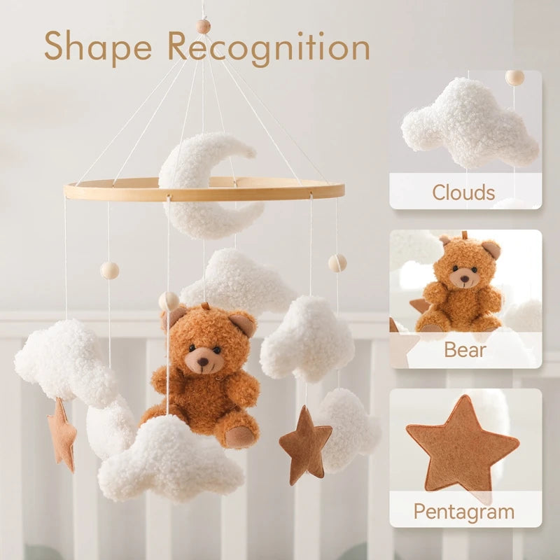 Children's mobile with teddy bear, clouds, and pentagram on a light background