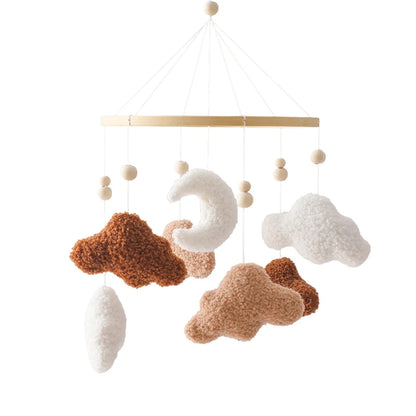 Decorative mobile with cloud and moon shapes on a white background