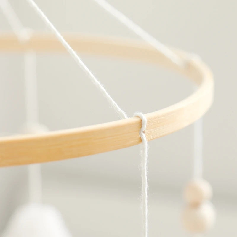 Close-up of a wooden embroidery hoop with white thread on a light background