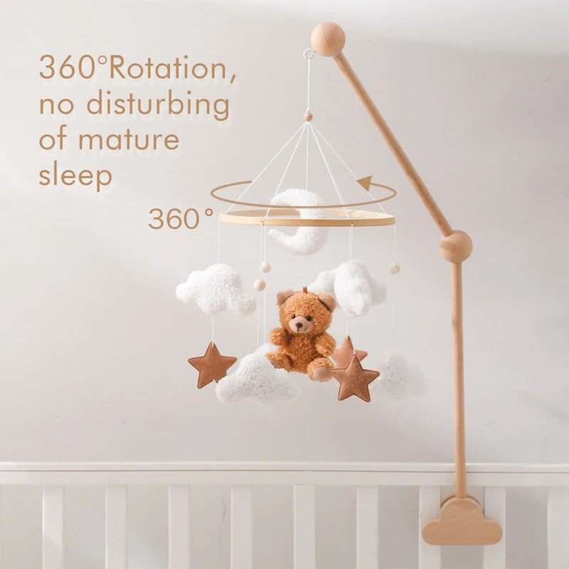 Baby crib mobile with teddy bear and stars hanging from a wooden stand, on a white background.