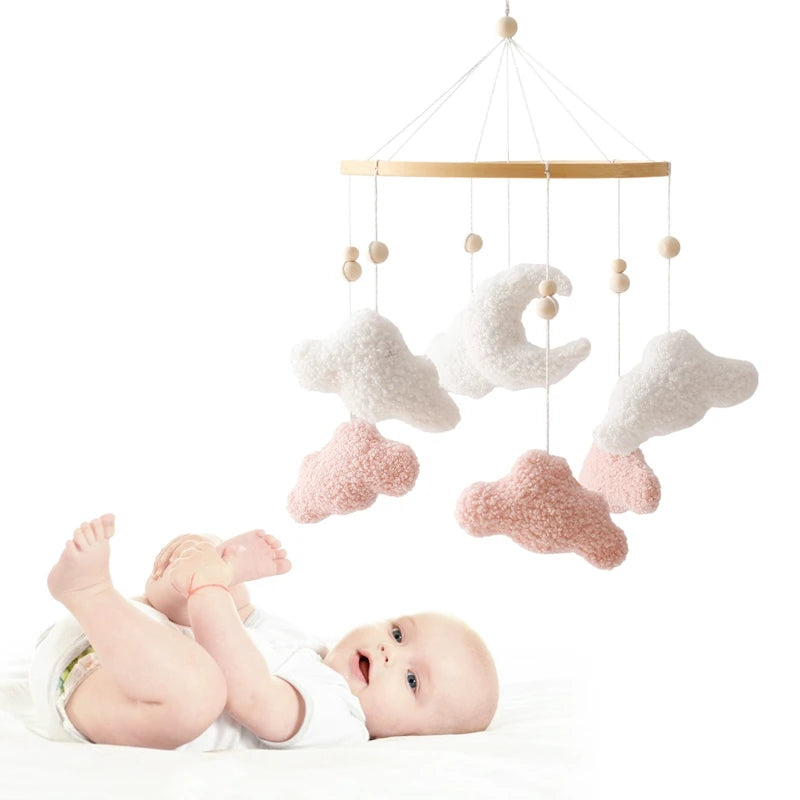 Baby mobile with clouds and stars hanging above a baby