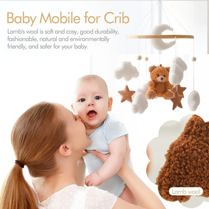 Baby mobile with teddy bear and stars hanging above a baby and mother, with text about lamb's wool.